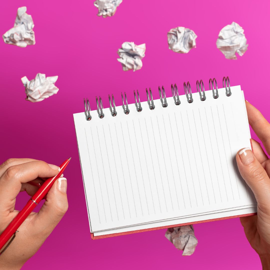 Blank sheet of paper surrounded by earlier drafts